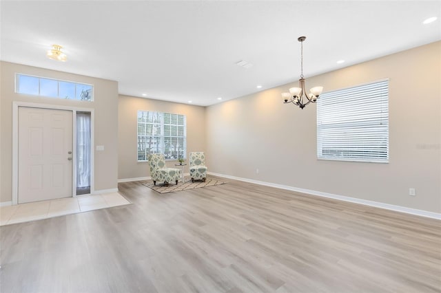 foyer with a notable chandelier and light hardwood / wood-style flooring