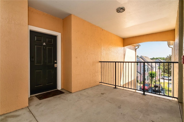 view of exterior entry featuring a balcony