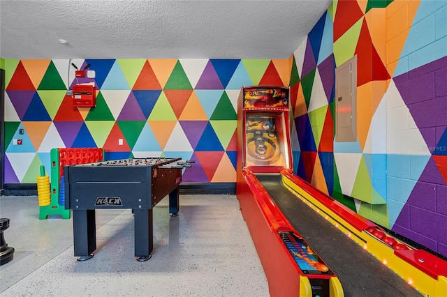 game room featuring a textured ceiling