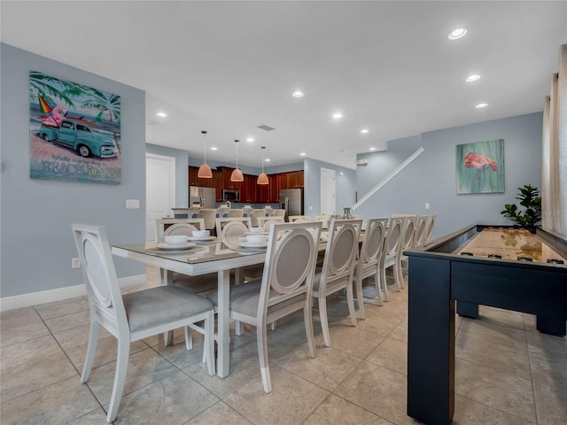 dining space featuring light tile floors