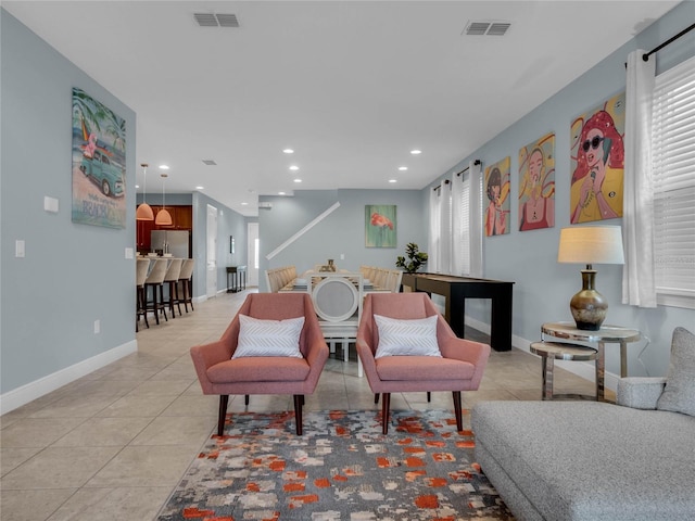 living room featuring tile floors and a wealth of natural light