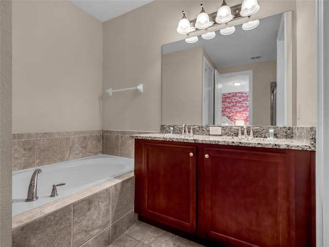 bathroom with dual sinks, oversized vanity, tile floors, and tiled tub