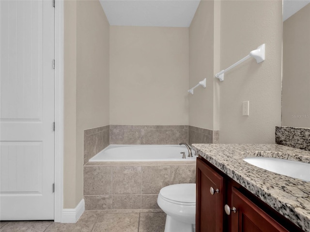 bathroom with tile flooring, vanity, toilet, and tiled tub