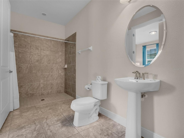 bathroom featuring a shower with shower curtain, toilet, and tile flooring