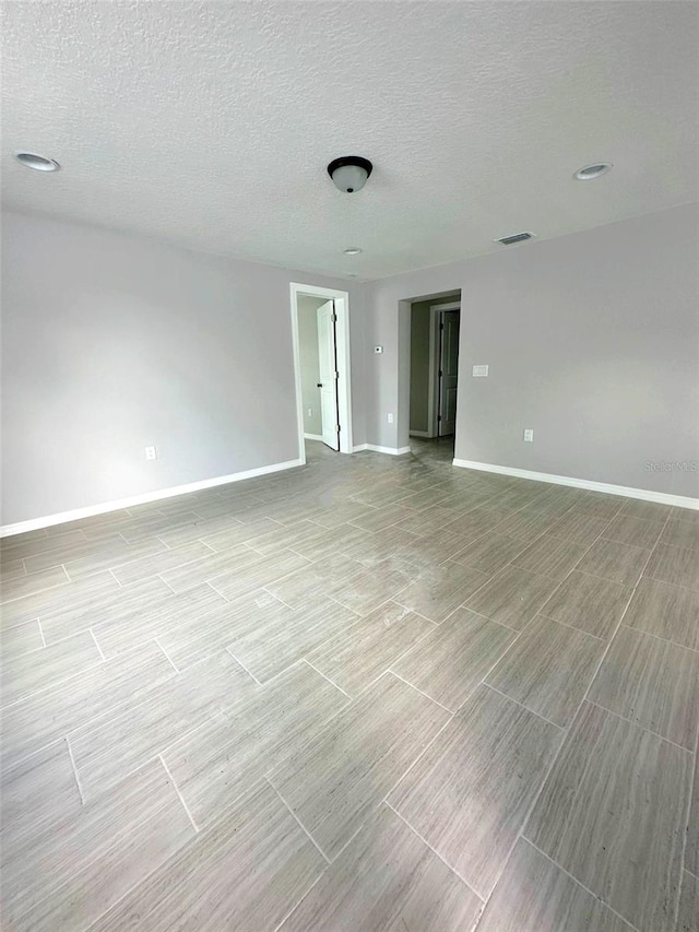 empty room featuring a textured ceiling