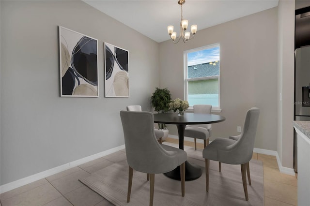 dining space with light tile patterned flooring and a notable chandelier