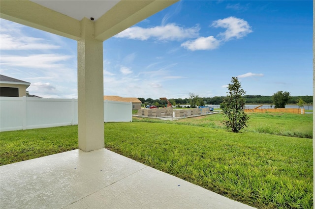 view of yard with a water view and a patio