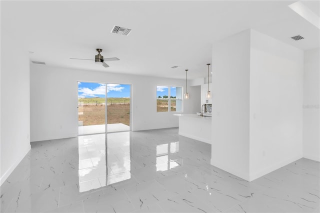 unfurnished room with sink, ceiling fan, and light tile floors