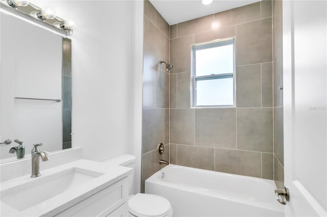 full bathroom with vanity, toilet, and tiled shower / bath combo