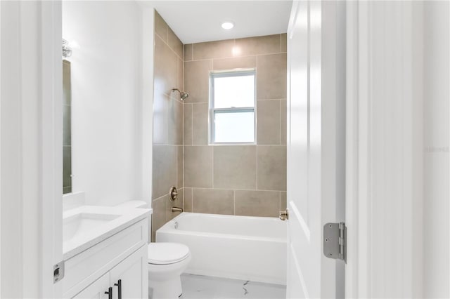 full bathroom featuring tiled shower / bath, toilet, and large vanity