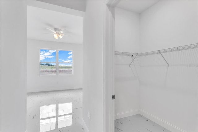 spacious closet featuring ceiling fan and tile floors