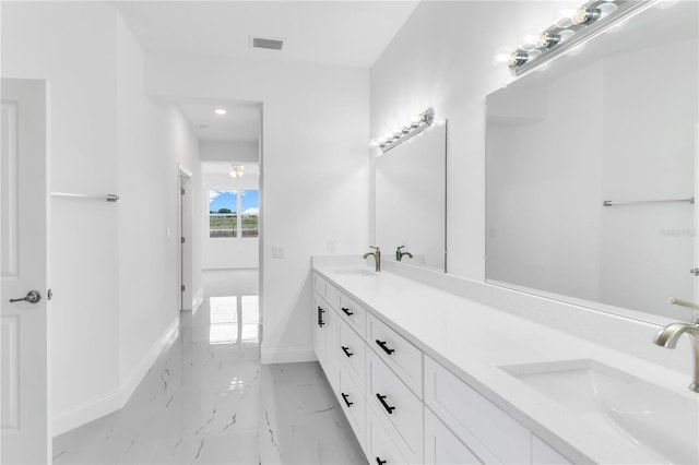 bathroom with double vanity and tile floors