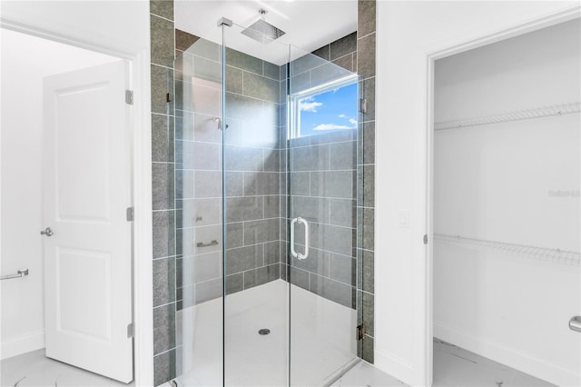 bathroom with a shower with door and tile floors