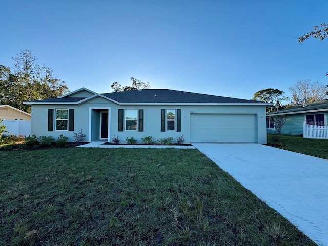 ranch-style home with a garage and a front lawn