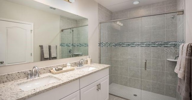 bathroom featuring vanity and an enclosed shower