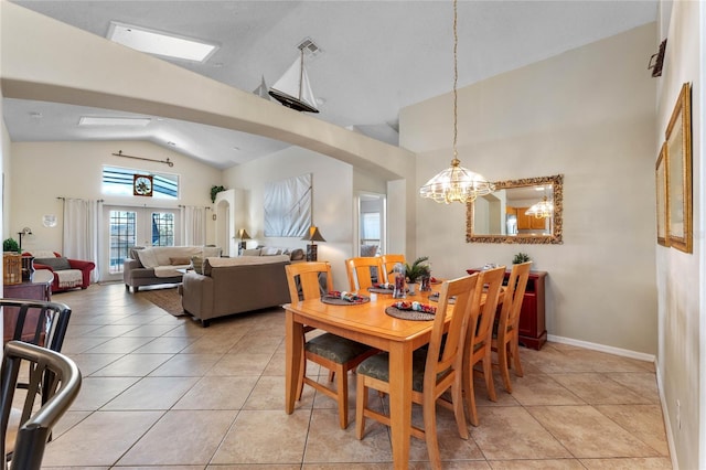 dining room with tile flooring, french doors, a chandelier, and high vaulted ceiling