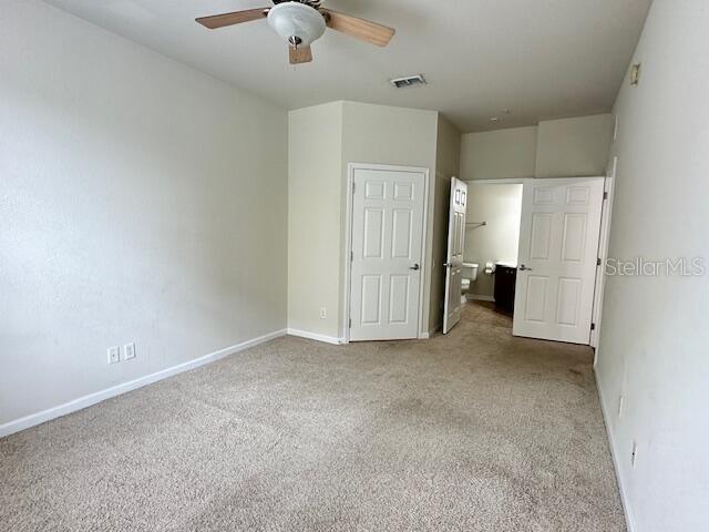 unfurnished bedroom with carpet flooring and ceiling fan