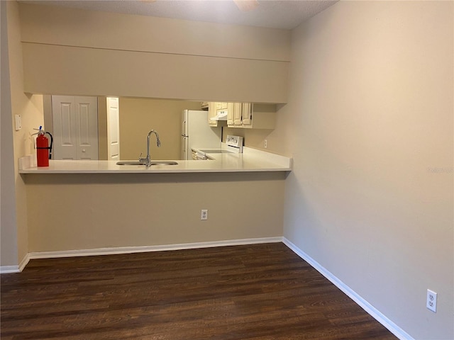 kitchen featuring dark hardwood / wood-style floors, white cabinets, white appliances, and sink