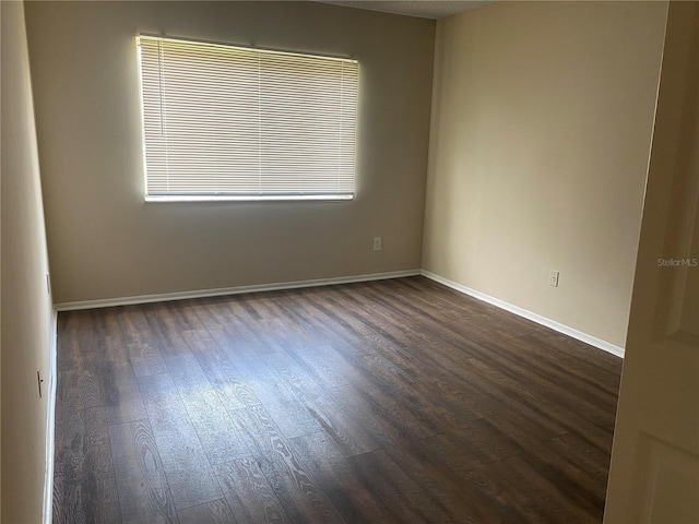 empty room with dark wood-type flooring