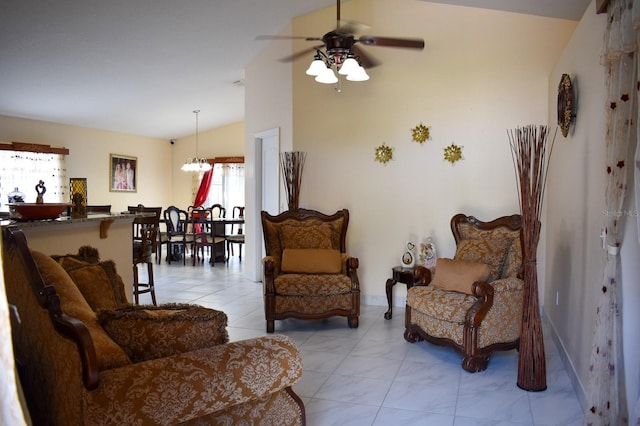 tiled living room featuring ceiling fan with notable chandelier and lofted ceiling