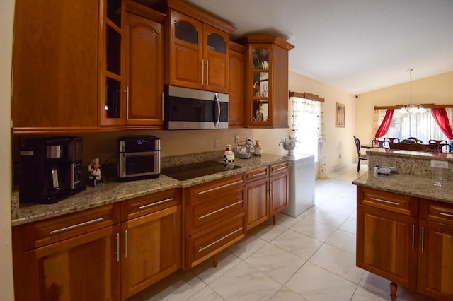 kitchen featuring black electric stovetop, light tile flooring, a notable chandelier, light stone counters, and lofted ceiling