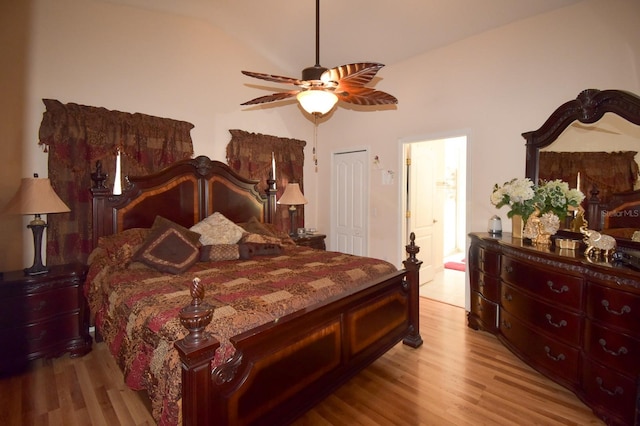 bedroom with a closet, light hardwood / wood-style floors, ceiling fan, and lofted ceiling