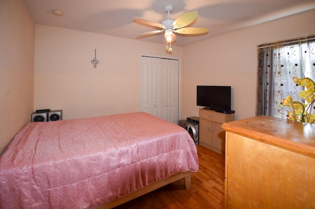 bedroom featuring hardwood / wood-style floors, a closet, and ceiling fan