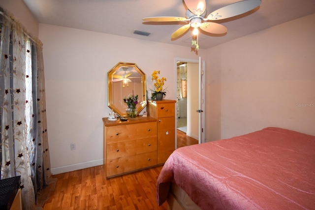 bedroom with ceiling fan and light hardwood / wood-style floors