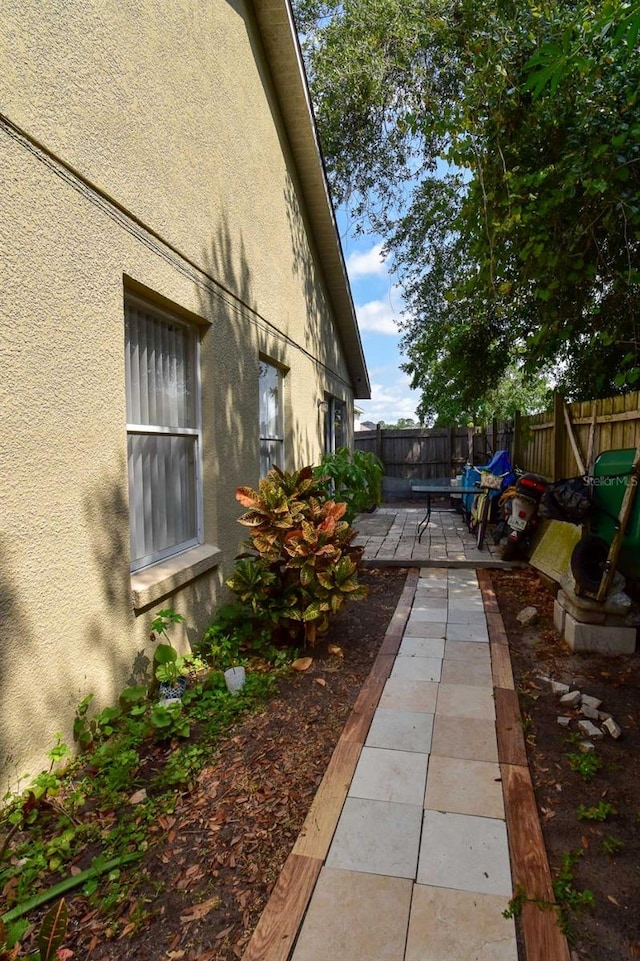 view of side of property featuring a patio