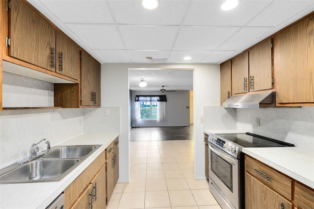 kitchen featuring a drop ceiling, ceiling fan, sink, light tile patterned floors, and stainless steel electric range oven