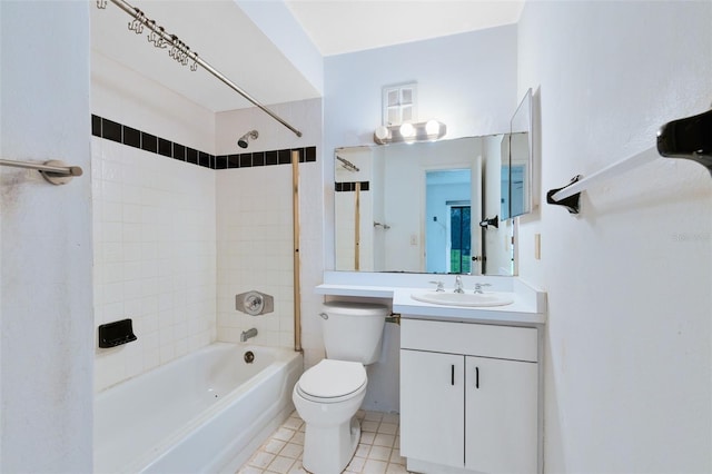 full bathroom featuring tile patterned floors, vanity, toilet, and tiled shower / bath