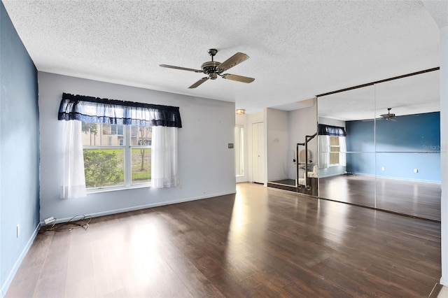 unfurnished living room featuring ceiling fan, a textured ceiling, and hardwood / wood-style flooring