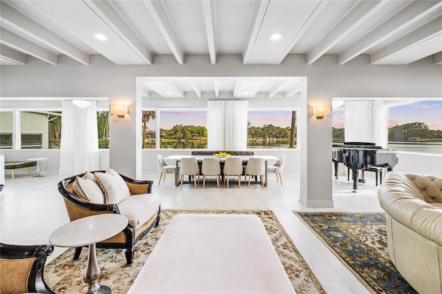 tiled living room with beam ceiling and a wealth of natural light