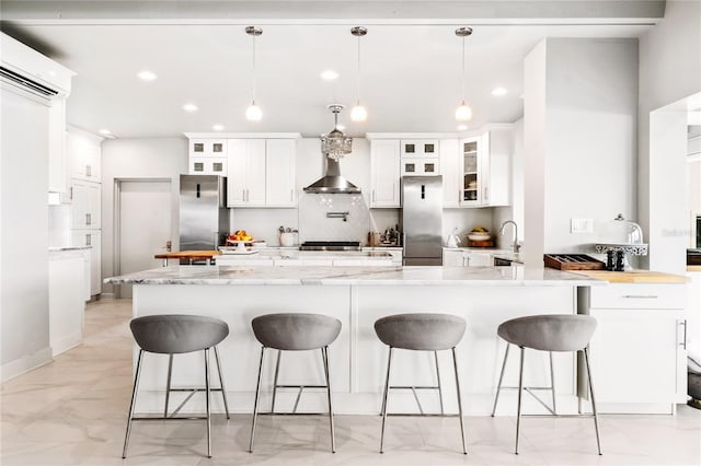 kitchen featuring white cabinetry, stainless steel fridge, light tile flooring, and pendant lighting