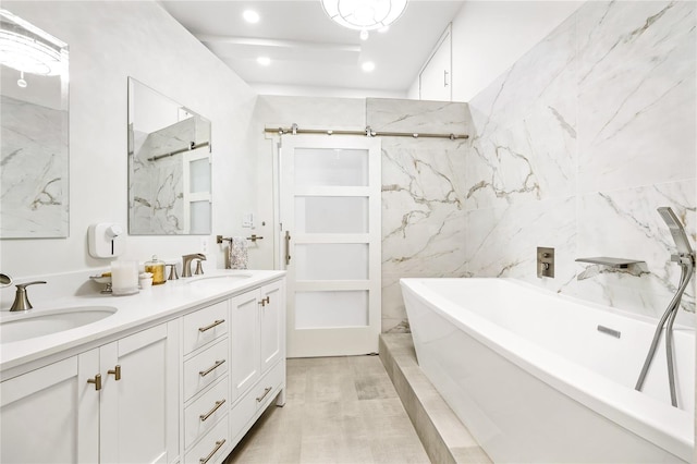 bathroom featuring vanity with extensive cabinet space, double sink, tile walls, and hardwood / wood-style floors