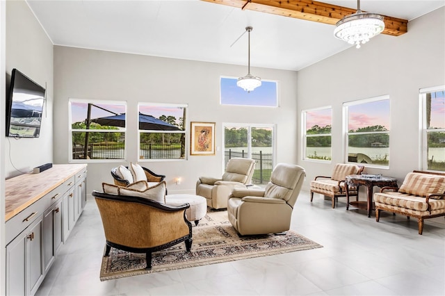 tiled living room with beam ceiling and an inviting chandelier