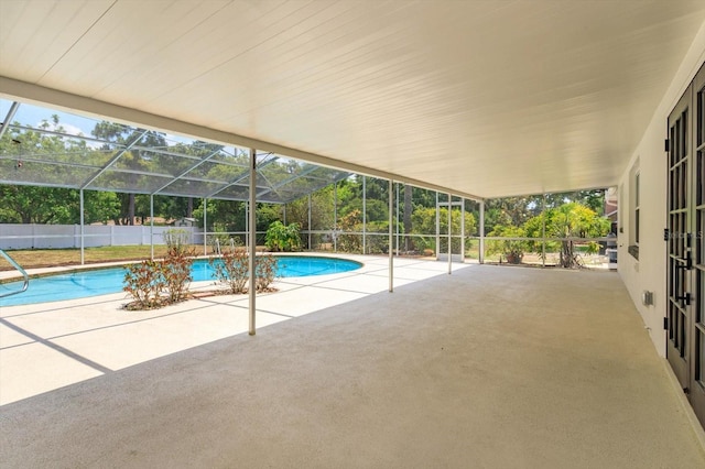 view of swimming pool with a lanai and a patio area