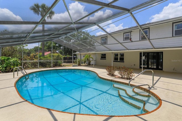 view of swimming pool featuring a patio and a lanai