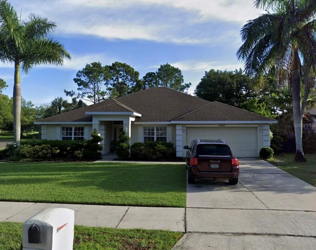 ranch-style home featuring a garage and a front yard