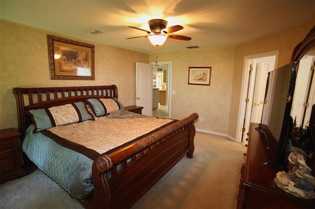 carpeted bedroom featuring a textured ceiling and ceiling fan