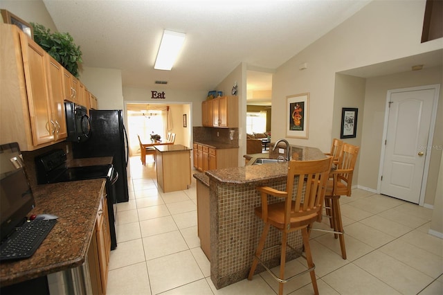 1201 Thornbury Ct, Winter Garden, FL 34787 - kitchen featuring a center island, a sink, light tile patterned flooring, and black appliances