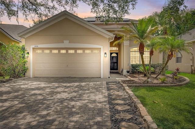 view of front of property featuring a yard and a garage