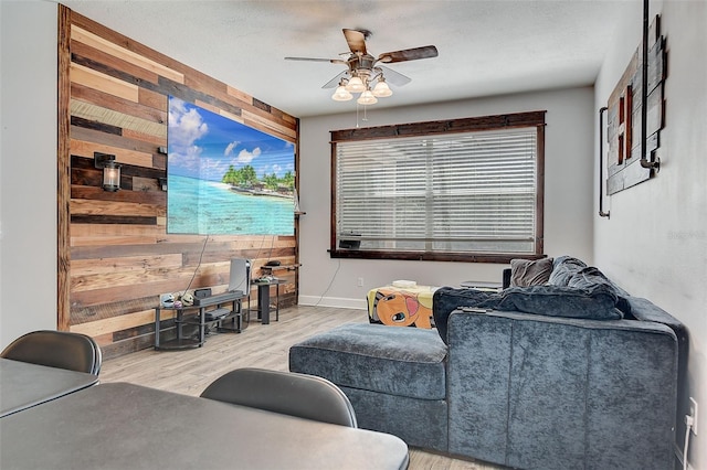 living room featuring ceiling fan and hardwood / wood-style floors