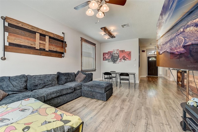 living room featuring hardwood / wood-style floors and ceiling fan