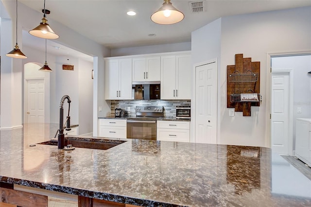 kitchen featuring sink, tasteful backsplash, white cabinetry, stainless steel range with electric cooktop, and pendant lighting