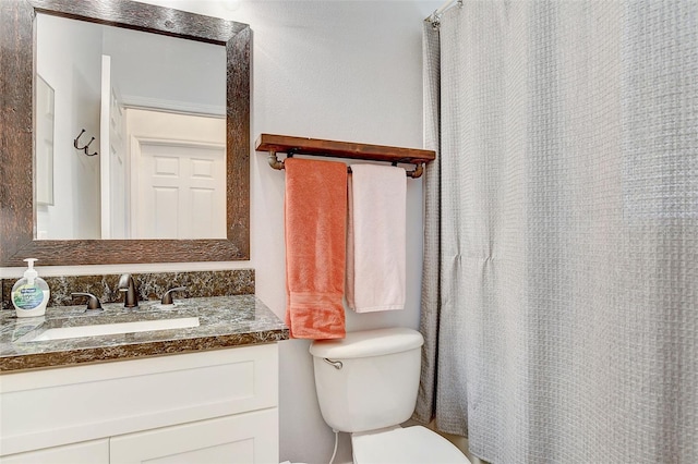 bathroom with toilet and vanity