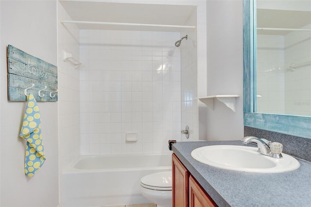 full bathroom with vanity, tiled shower / bath combo, and toilet