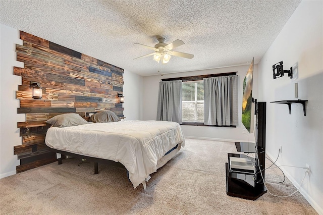 bedroom with wood walls, light colored carpet, ceiling fan, and a textured ceiling