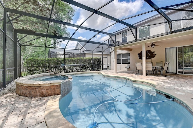 view of swimming pool with a patio area, ceiling fan, an in ground hot tub, and a lanai