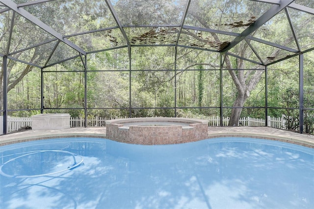 view of swimming pool featuring glass enclosure and an in ground hot tub